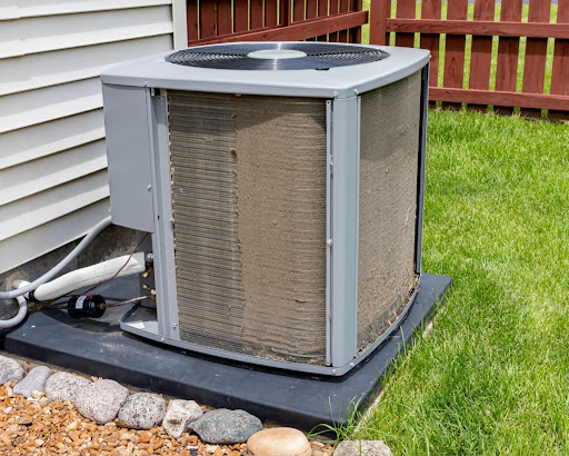 A central air conditioner with the coils exposed.