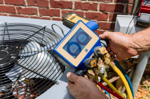 A technician performing a service on an outdoor AC unit.