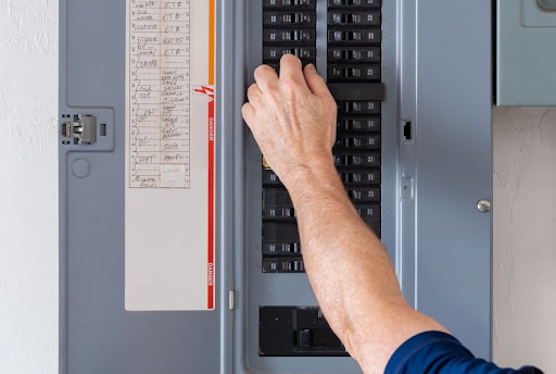 Homeowner fixing AC tripped breaker.